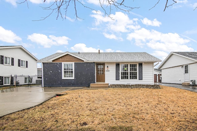 single story home with a patio, fence, and roof with shingles