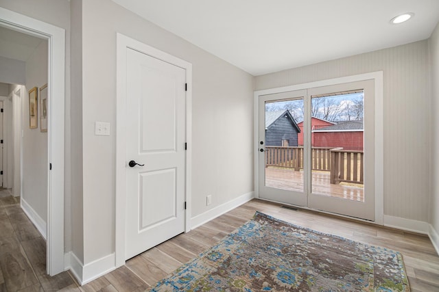 doorway to outside with recessed lighting, baseboards, and wood finished floors