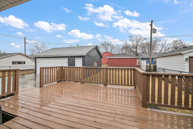 wooden terrace featuring an outbuilding and a garage