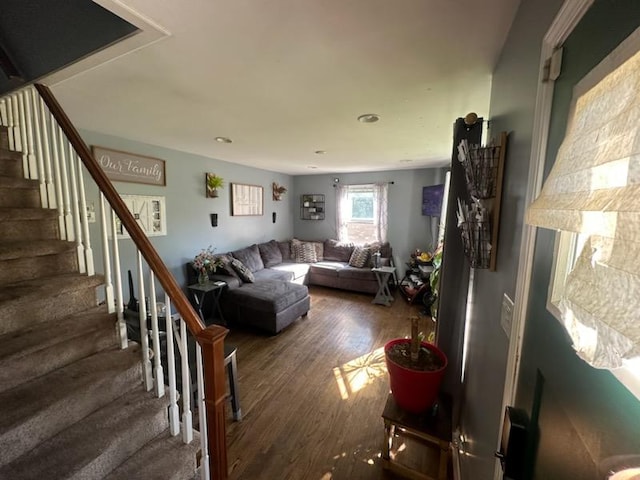 living area featuring wood finished floors and stairs