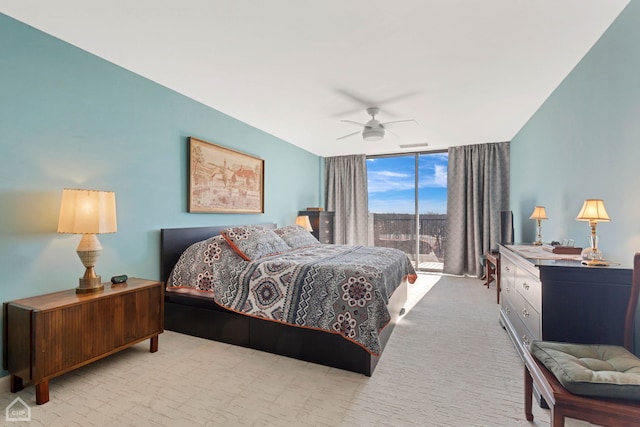 bedroom featuring carpet flooring, ceiling fan, and expansive windows