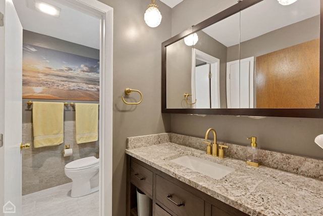 bathroom featuring toilet and vanity