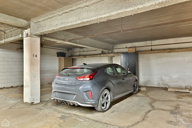 parking garage featuring concrete block wall