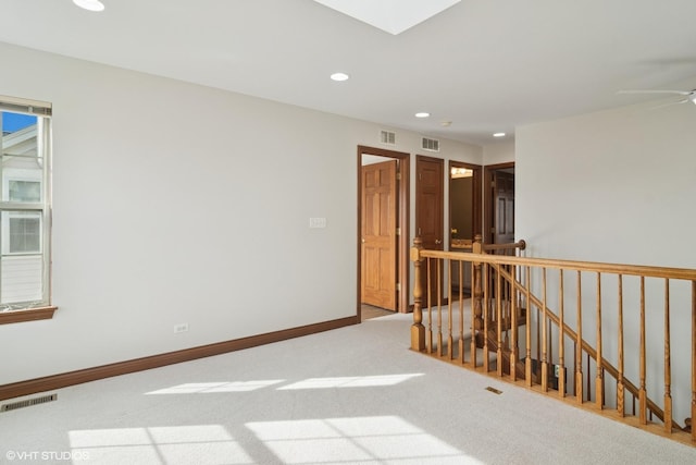 empty room featuring recessed lighting, baseboards, and visible vents