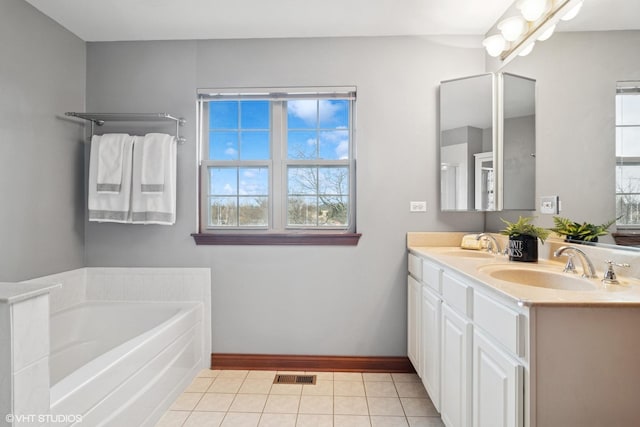 full bath featuring visible vents, double vanity, a bath, tile patterned floors, and a sink