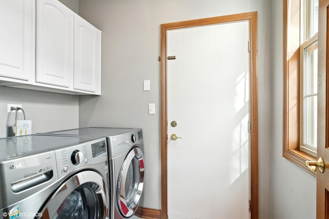 washroom featuring separate washer and dryer and cabinet space