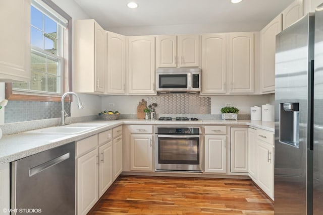 kitchen with light countertops, recessed lighting, light wood finished floors, and stainless steel appliances