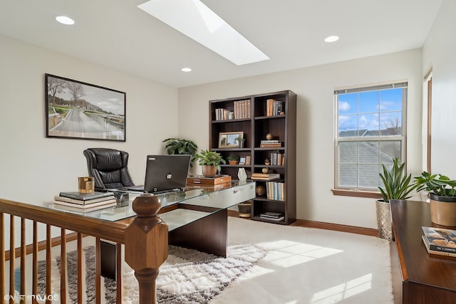 office space featuring a skylight, recessed lighting, and baseboards