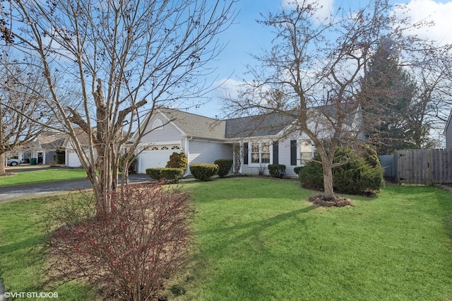 single story home featuring driveway, an attached garage, a front yard, and fence