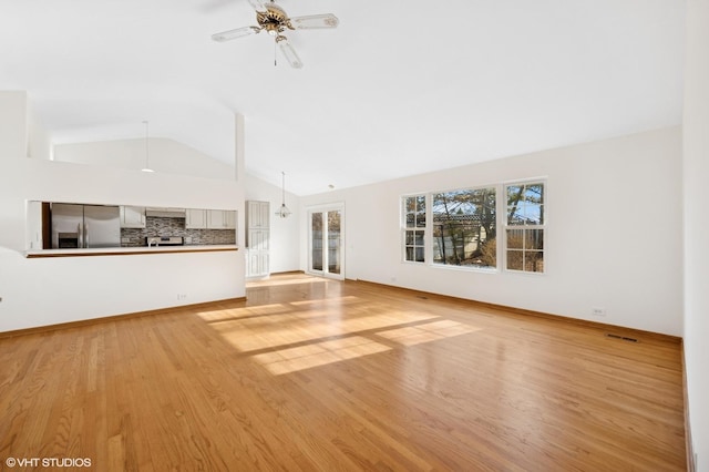 unfurnished living room featuring visible vents, light wood-style flooring, ceiling fan, and vaulted ceiling