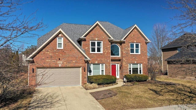 traditional-style house with brick siding, driveway, and a shingled roof