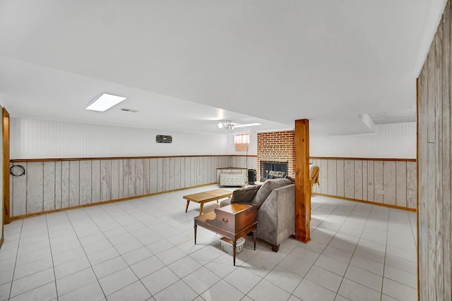 living room with light tile patterned floors and a fireplace