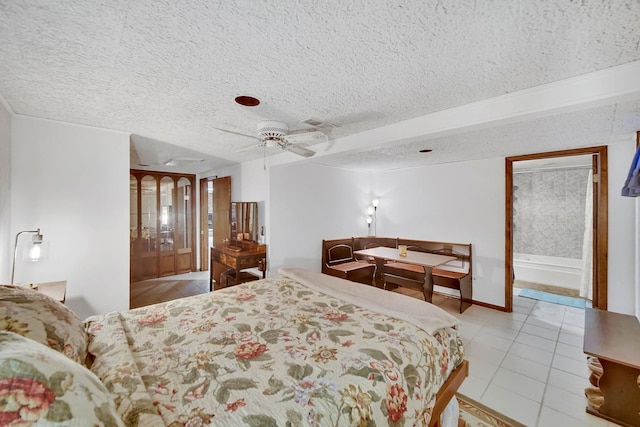 bedroom with baseboards, a textured ceiling, ceiling fan, and tile patterned flooring