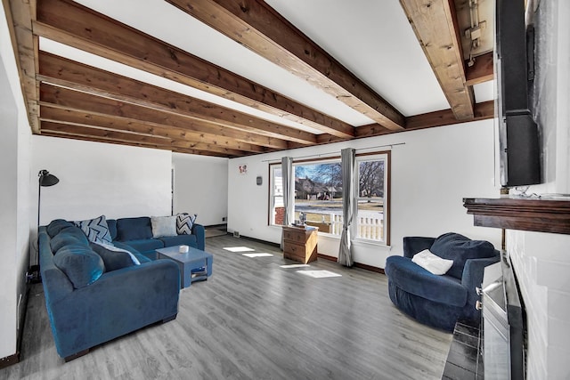 living room with beam ceiling, wood finished floors, and baseboards