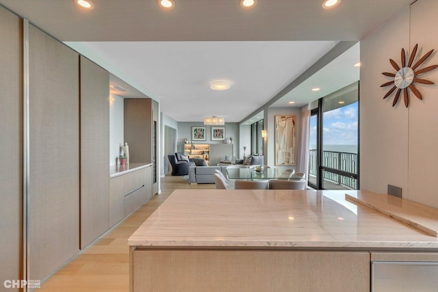 kitchen featuring recessed lighting, modern cabinets, open floor plan, and light wood finished floors