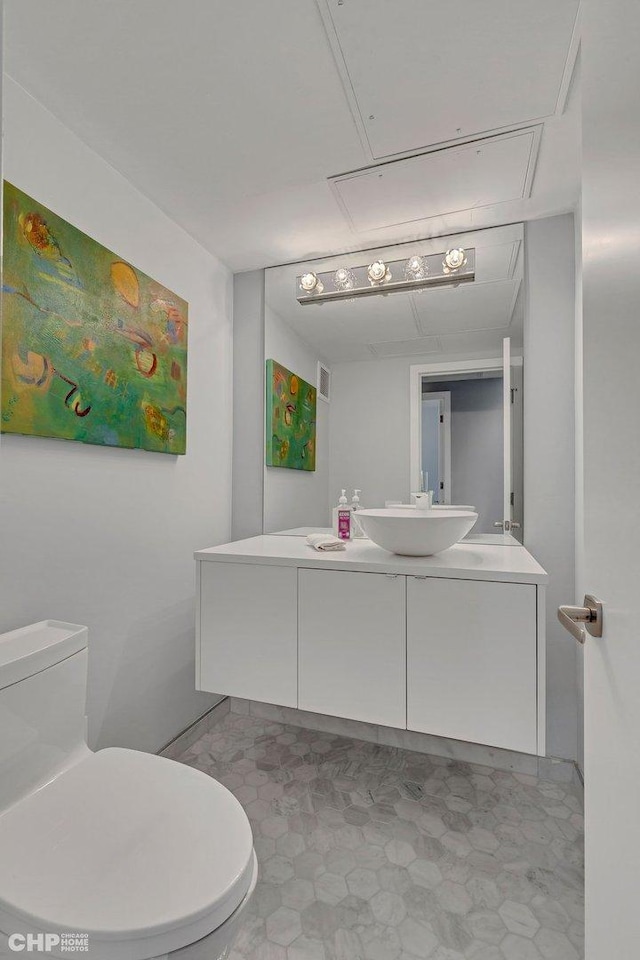 bathroom with tile patterned floors, visible vents, toilet, and vanity