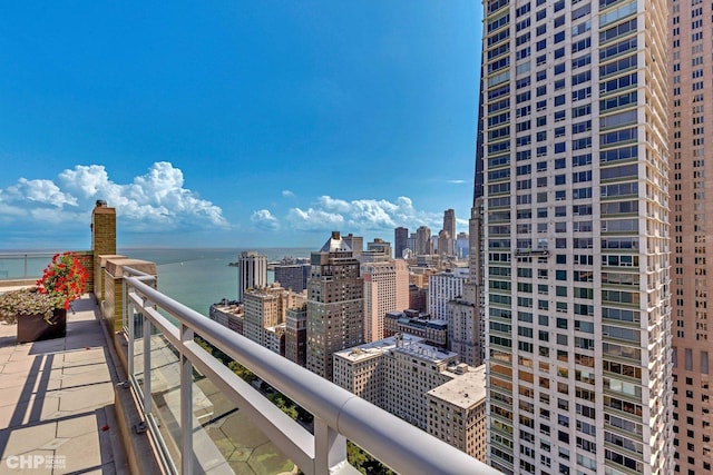 balcony featuring a water view and a view of city