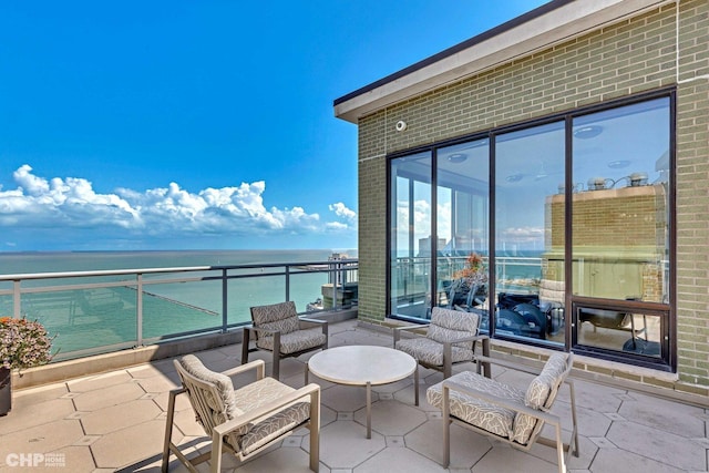 view of patio with a balcony and a water view