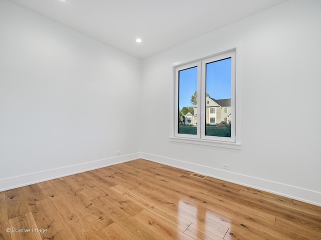 empty room with recessed lighting, visible vents, baseboards, and light wood finished floors