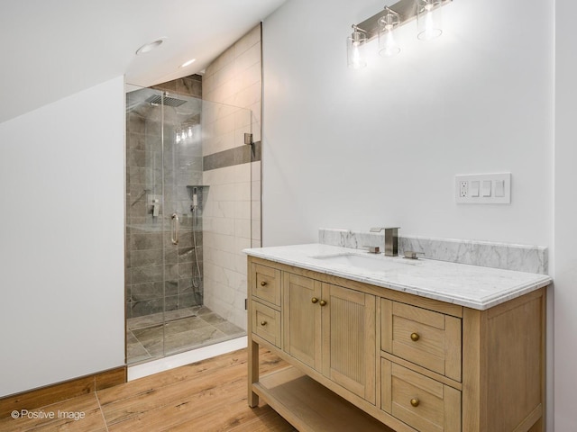 bathroom featuring vanity, recessed lighting, wood finished floors, and a stall shower