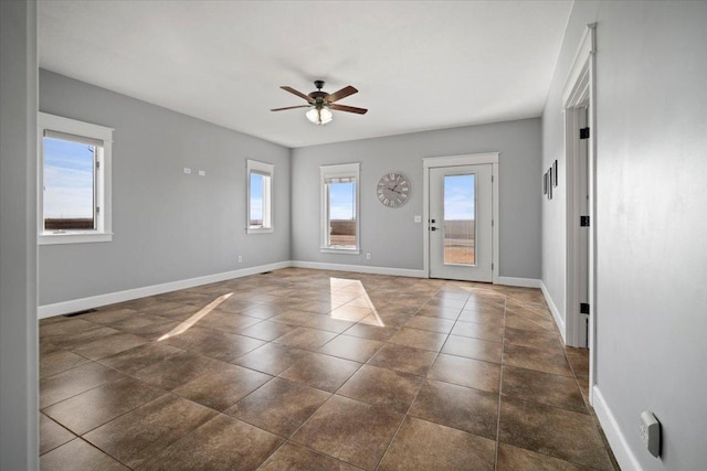 entrance foyer with visible vents, plenty of natural light, baseboards, and ceiling fan