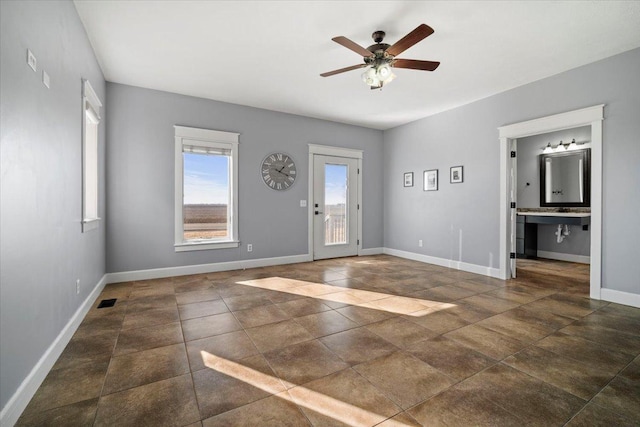 entryway with visible vents, baseboards, and a ceiling fan