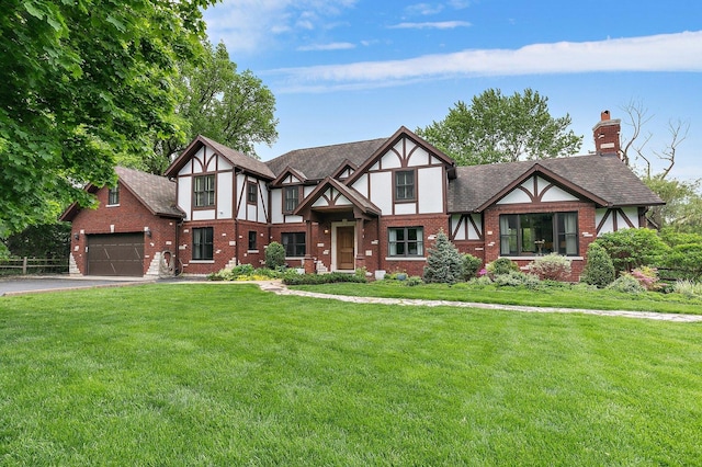 english style home with brick siding, a front lawn, aphalt driveway, roof with shingles, and stucco siding