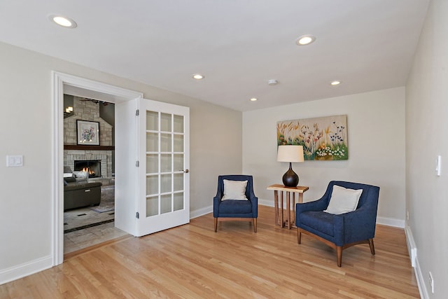 sitting room with recessed lighting, baseboards, and wood finished floors