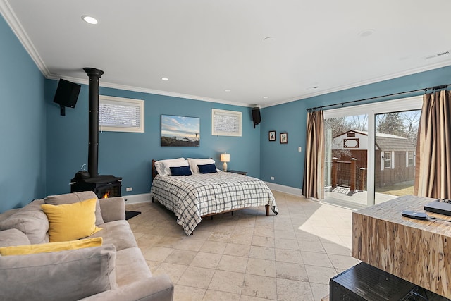 bedroom with access to exterior, crown molding, a wood stove, and baseboards