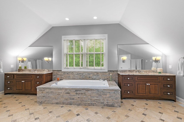 full bathroom featuring two vanities, recessed lighting, a sink, vaulted ceiling, and a garden tub