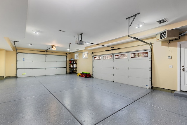 garage featuring a garage door opener and visible vents