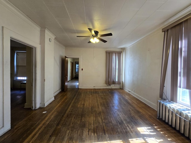 spare room with ceiling fan, baseboards, radiator heating unit, ornamental molding, and wood finished floors