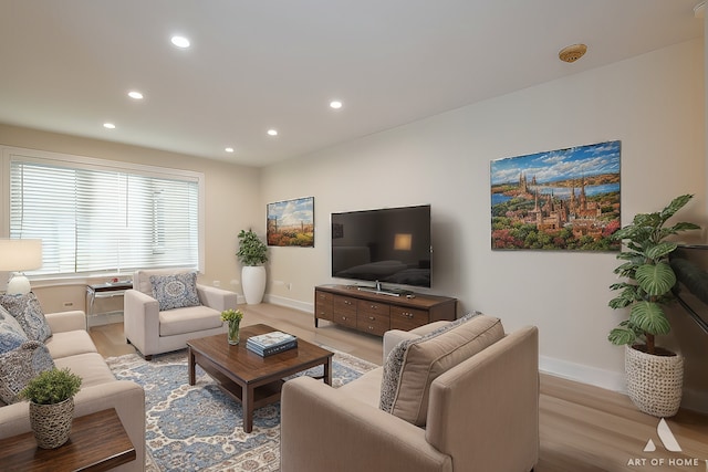 living area with light wood finished floors, recessed lighting, and baseboards