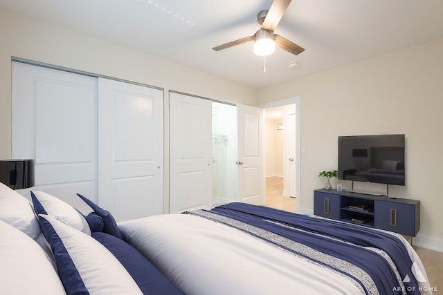 bedroom with a ceiling fan, baseboards, and light wood-type flooring