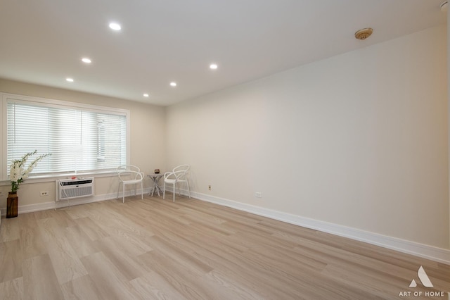 unfurnished room featuring baseboards, recessed lighting, light wood-type flooring, and a wall mounted AC