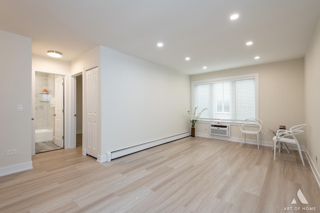 empty room with recessed lighting, a baseboard radiator, baseboards, and light wood-style flooring