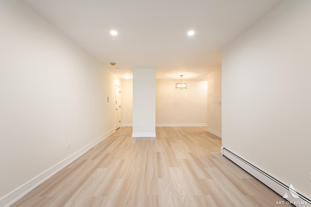 unfurnished room featuring recessed lighting, a baseboard radiator, baseboards, and light wood-style floors