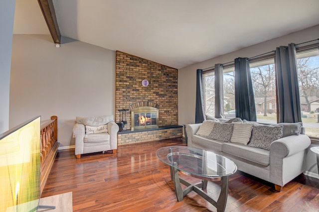 living room with hardwood / wood-style floors, a fireplace, and vaulted ceiling with beams