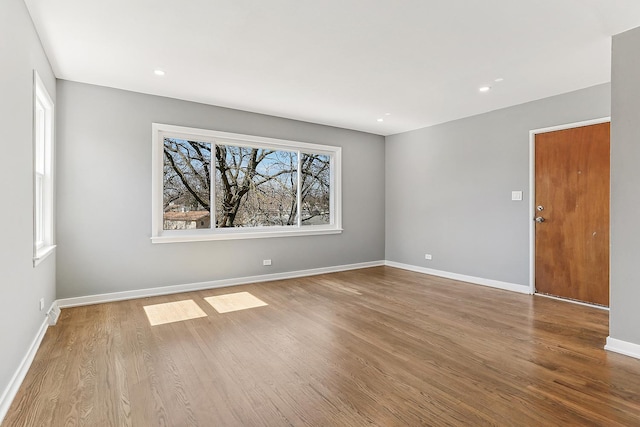 unfurnished room featuring recessed lighting, baseboards, and wood finished floors