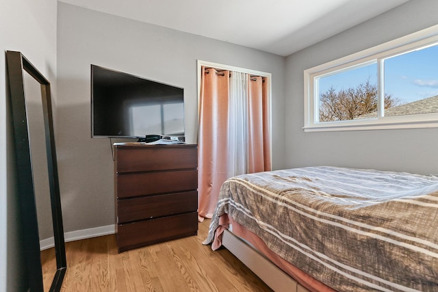 bedroom featuring light wood-style flooring and baseboards