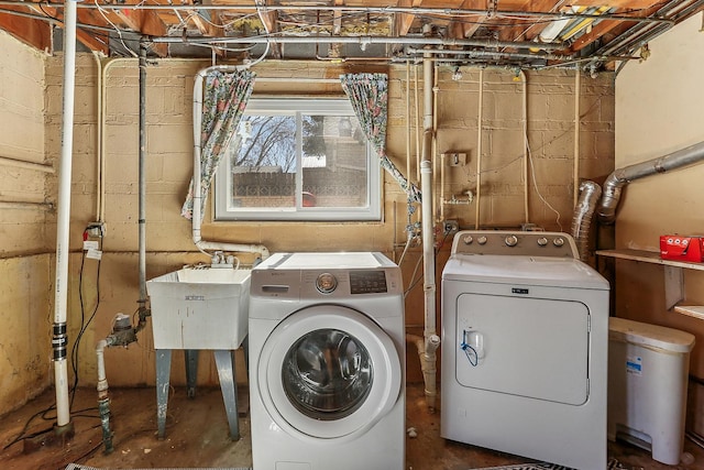 laundry area featuring laundry area, washer and dryer, and a sink