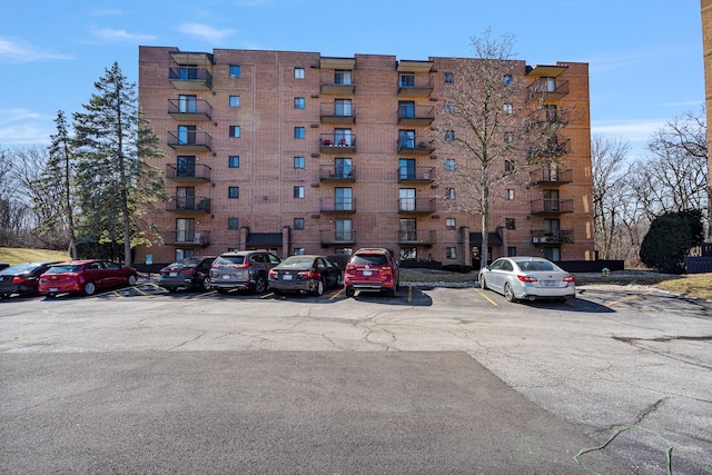 view of building exterior with uncovered parking