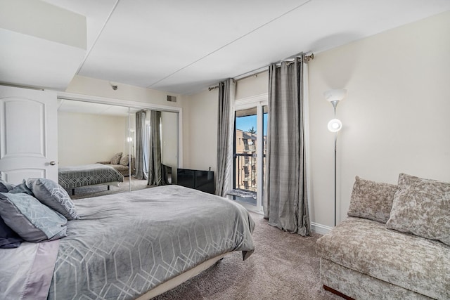 carpeted bedroom featuring visible vents, a closet, and access to exterior