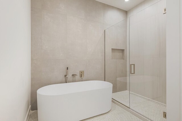 bathroom with a shower stall, baseboards, toilet, double vanity, and a sink