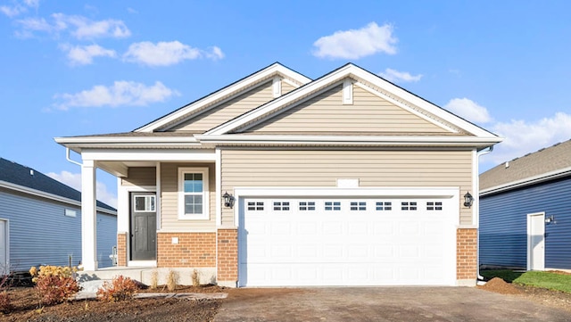 view of front of house with brick siding, driveway, and an attached garage