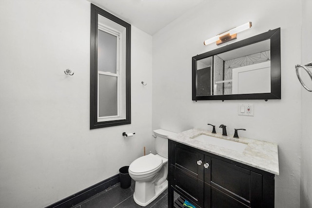 bathroom with tile patterned flooring, toilet, vanity, and baseboards