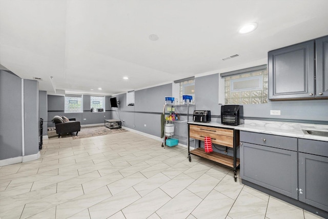 kitchen with visible vents, baseboards, recessed lighting, gray cabinets, and open floor plan