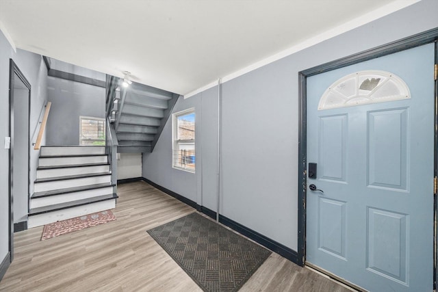 entryway with stairway, baseboards, and wood finished floors