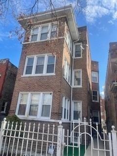 view of building exterior with a fenced front yard