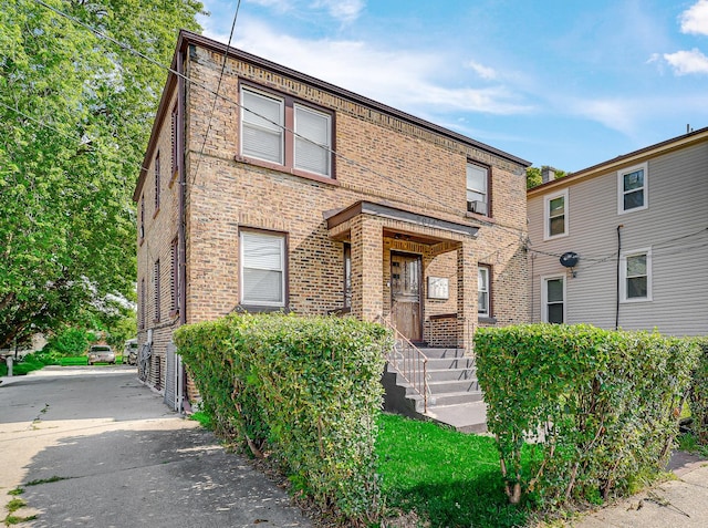 townhome / multi-family property with brick siding